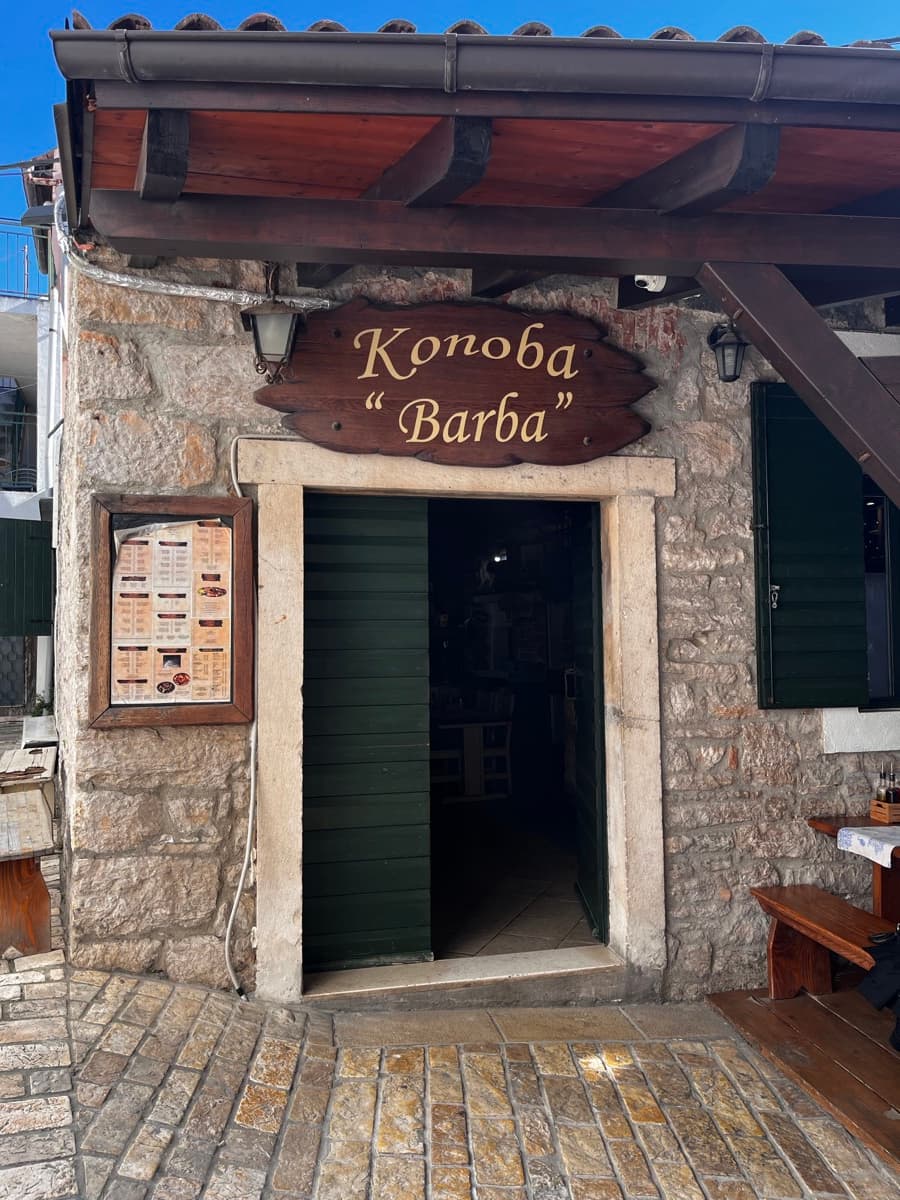 Konoba Barba entrance in Biograd na Moru — stone walls and a wooden sign