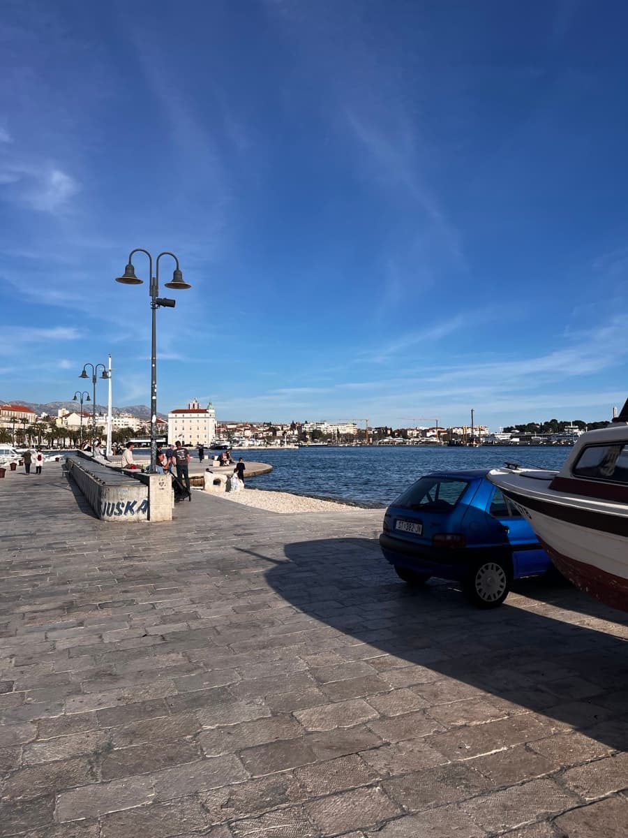 Split Riva waterfront promenade with Jadrolinija ferries in the harbor